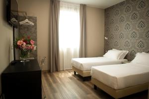 Postel nebo postele na pokoji v ubytování Hotel Della Rosa