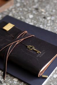 a key sitting on top of a black purse at Arthur Hotel Canton Tower Guangzhou-广州塔骑士物语酒店 in Guangzhou