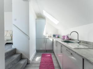 a kitchen with a sink and a counter with a stair at Pass the Keys Lovely Centrally located Apartment in Westbourne in Bournemouth