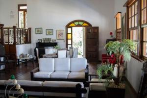 a living room with two white couches at Pousada Lagoa in Belo Horizonte