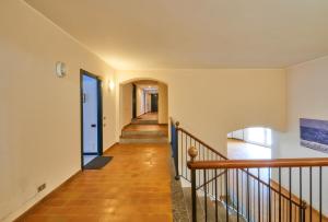a hallway of a home with a staircase and a stair case at Aria di Breva in Lierna +30 photos