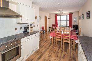 a kitchen and dining room with a table and chairs at Alban Rise in Keswick