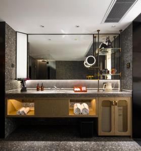 a bathroom with a sink and a mirror at Arthur Hotel Canton Tower Guangzhou-广州塔骑士物语酒店 in Guangzhou