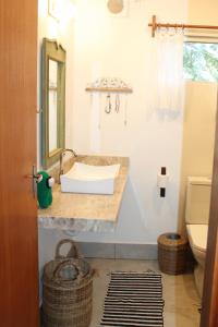 a bathroom with a sink and a toilet at GREEN HOUSE ARRAIAL D'AJUDA in Arraial d'Ajuda +27 photos