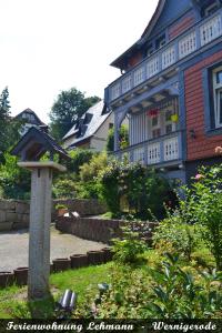 a house with a bird bath in the yard at Ferienwohnung Lehmann - Wernigerode in Wernigerode