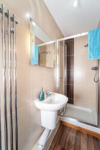 a white bathroom with a sink and a shower at Bridge House Apartment 2 in Keswick +20 photos
