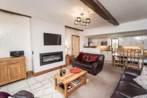 a living room with a couch and a table at Bridge House Apartment 2 in Keswick