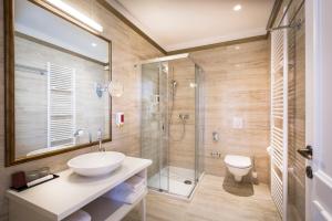 a bathroom with a sink and a glass shower at Hotel Bellevue - Liburnia in Opatija