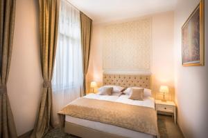 a bedroom with a bed and a window at Hotel Bellevue - Liburnia in Opatija