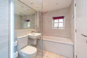 a bathroom with a toilet and a sink and a bath tub at Bridge Mews in Keswick +11 photos