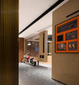 a motorcycle is parked in a hallway of a building at Arthur Hotel Canton Tower Guangzhou-广州塔骑士物语酒店 in Guangzhou