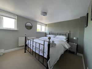 a bedroom with a bed and two windows at Mountain View in Keswick