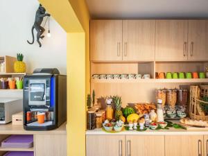 a kitchen with a microwave and some food at ibis Styles Beaulieu sur Mer in Beaulieu-sur-Mer