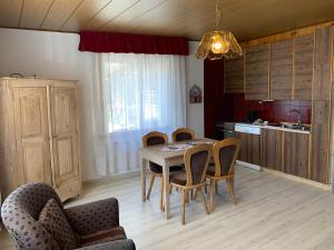 a kitchen with a dining room table and chairs at El Ladinia Someda in Moena