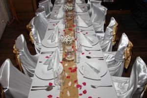 a long table with white plates and hearts on it at Nábřežní terasy in Žďár nad Sázavou