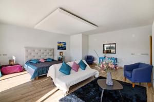 a bedroom with a bed and a couch and a table at Villa Rosana in Albufeira
