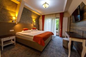 Postel nebo postele na pokoji v ubytování Moviliţa Residence