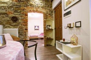 - un salon avec une table et un mur en briques dans l'établissement LA PERLA piccolo appartamento in piazza, à Orta San Giulio