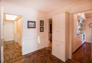 a large room with white walls and wooden floors at Casa Orta appartamento con vista lago in Orta San Giulio