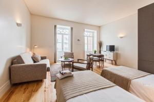 a living room with a bed and a couch at bnapartments Loftpuzzle in Porto