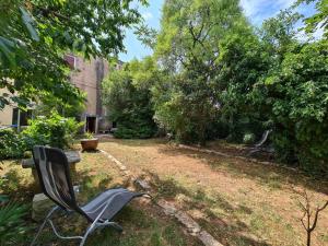 a bench sitting in the yard of a garden at House Krnica 2120 in Krnica