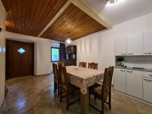 a kitchen and dining room with a table and chairs at House Krnica 2120 in Krnica
