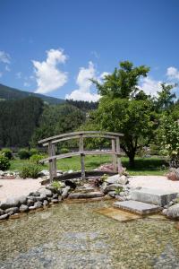 a wooden bridge over a stream of water at Ledererhof in Aschau