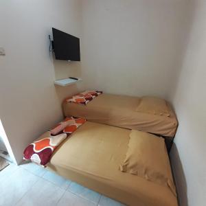 Postel nebo postele na pokoji v ubytování GIO Guesthouse Bogor