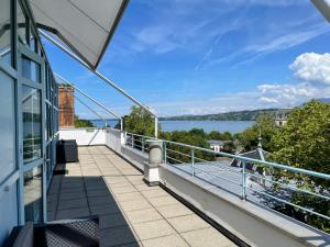 a balcony with a view of the water at Geneva Hostel in Geneva