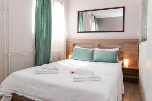 a bedroom with a white bed with towels on it at DELTA CITY New Belgrade Apartment free public parking in Belgrade