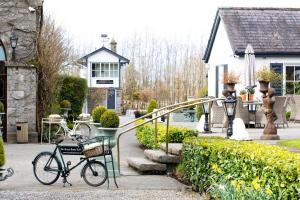 a bike parked in front of a house at The Station House Hotel in Kilmessan