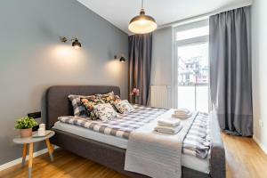 a bedroom with a bed and a window at WrocApartments StarCenter in Wrocław