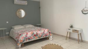 a bedroom with a bed and a table and a mirror at Villa Maya in Lambesc
