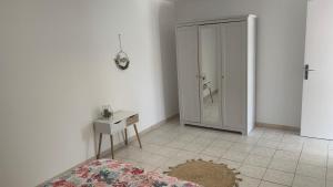a bedroom with a closet and a bed and a table at Villa Maya in Lambesc +6 photos