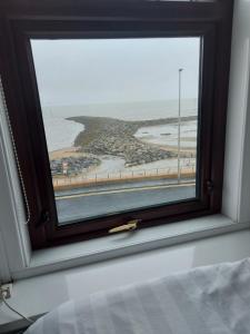 a window with a view of a beach at Craigwell in Morecambe