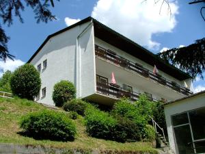 a building with balconies on the side of it at Pension Weiss in Drobollach am Faaker See