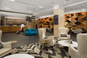 a lobby of a hotel with chairs and tables at Rydges Campbelltown in Campbelltown