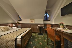 A bed or beds in a room at Hotel Podhrad