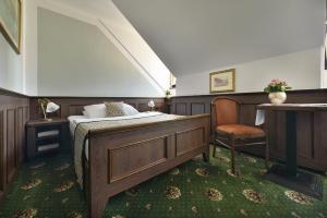 A bed or beds in a room at Hotel Podhrad