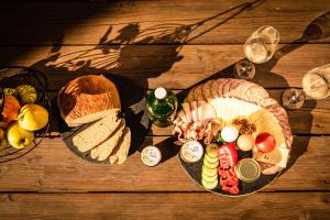 a wooden table with a plate of food and bread at Mayr-Hof (Mank) in Seimetzbach