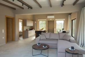 a living room with a couch and two tables at Sweet Villas in Lygia