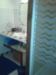 a bathroom with a sink and a mirror at Les chambres de Kerael in Crozon +50 photos