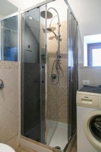 カターニアにあるMonolocale il Tindaroのバスルーム(ガラスドア付きのシャワー付)