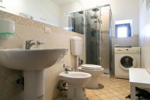 a bathroom with a sink and a toilet and a shower at Monolocale il Tindaro in Catania