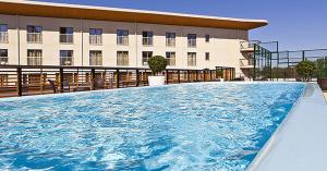a large swimming pool in front of a building at Villa Gardens in Imatra