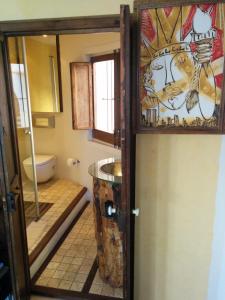 a bathroom with a toilet and a glass door at Tot Gaviota in Sitges