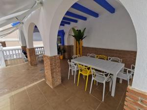 a dining room with a table and chairs at La Buganvilla Beach House in Calahonda