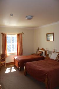 Postel nebo postele na pokoji v ubytování Dan O'Hara Farmhouse B&B