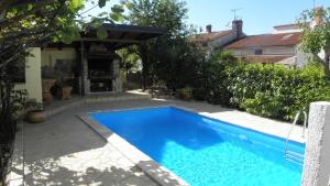 a swimming pool in the backyard of a house at Apartment Klesinger in Poreč