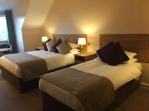 A bed or beds in a room at Deebert House Hotel